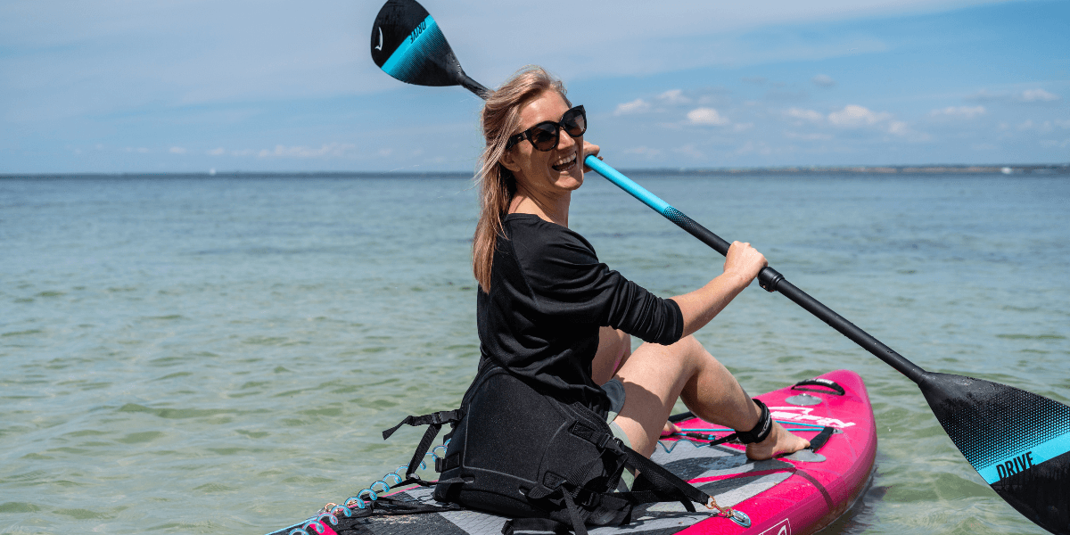 woman smiling on a paddleboard