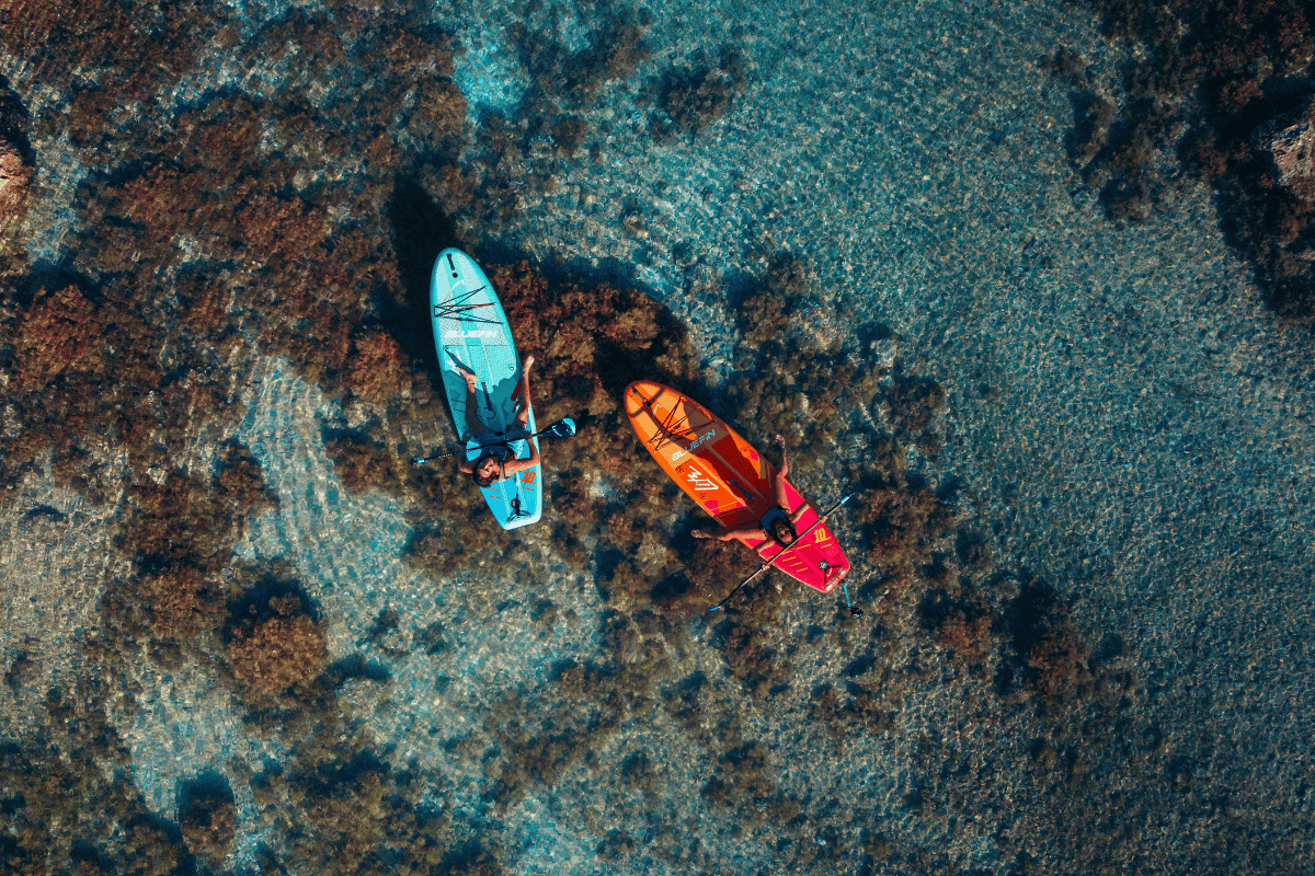 two people on paddleboards in the ocean