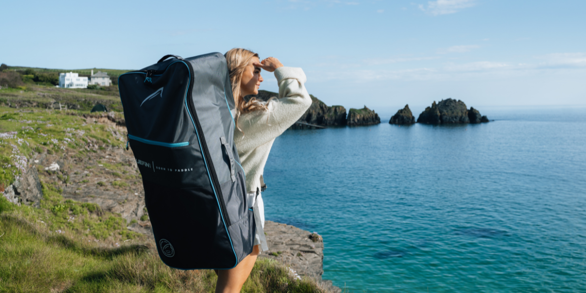 woman with a paddleboard on her back