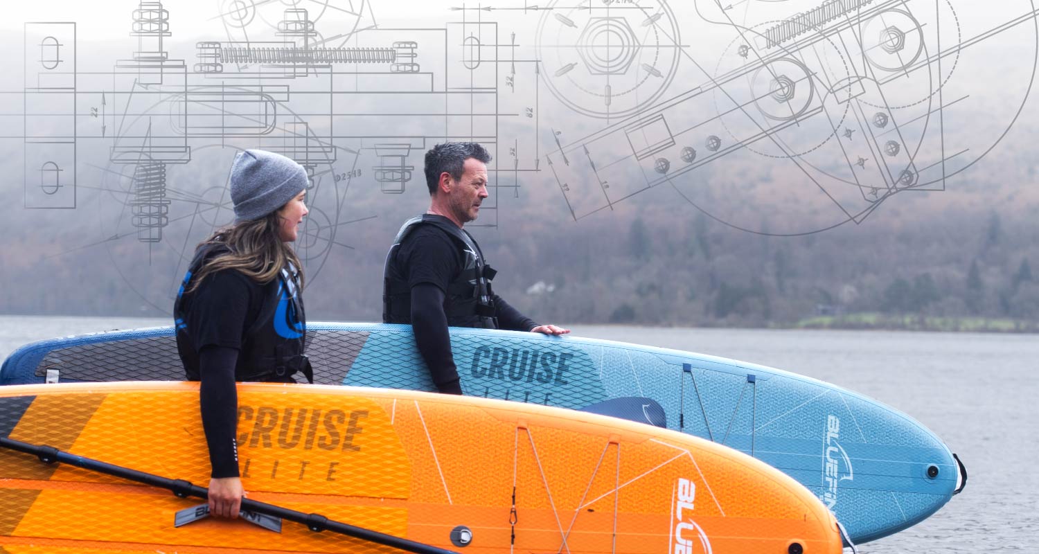 Two paddleboarders stand by the water with SUP boards, accompanied by design schematics in the background.