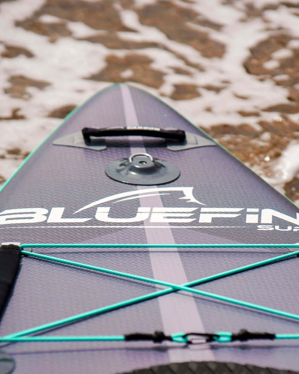 Close-up of a Bluefin SUP board with Bluefin logo on the nose of the inflatable paddle board