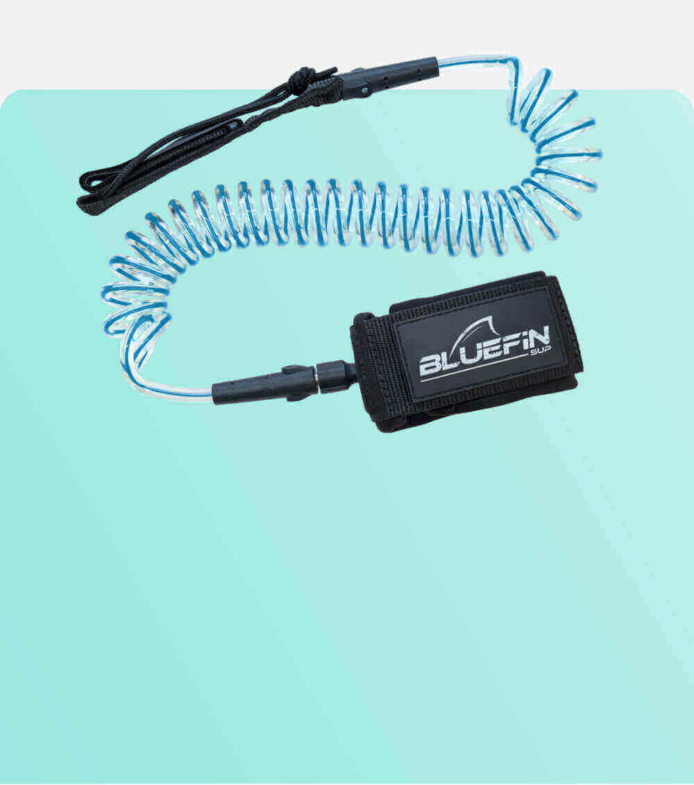 Coiled safety leash with black strap and blue cord, designed for paddleboarding.