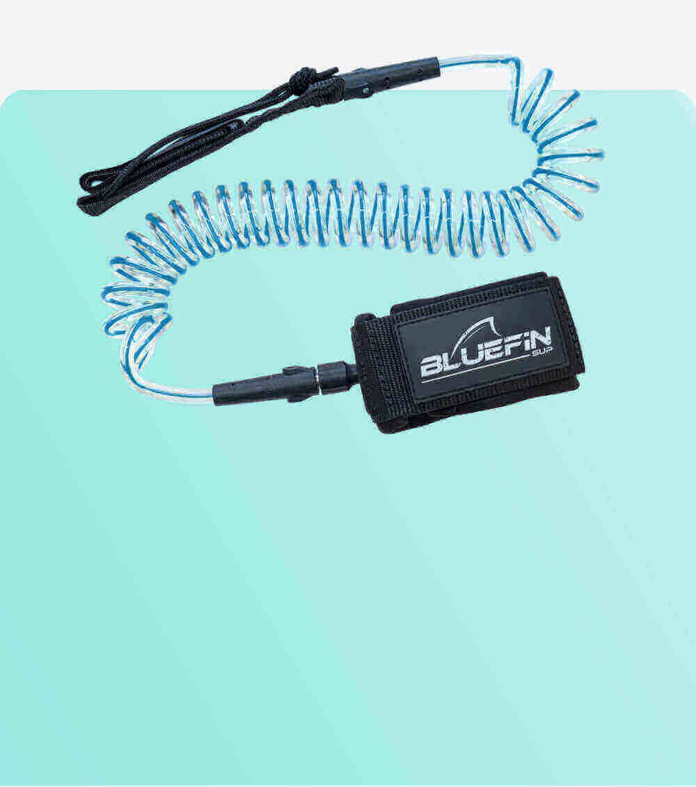 Coiled safety leash with black strap and blue cord, designed for paddleboarding.