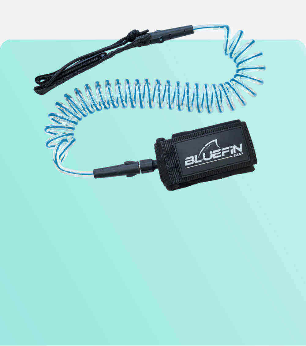 Coiled safety leash with black strap and blue cord, designed for paddleboarding.