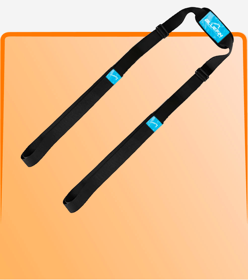 Black inflatable paddle board carry strap on a peach background