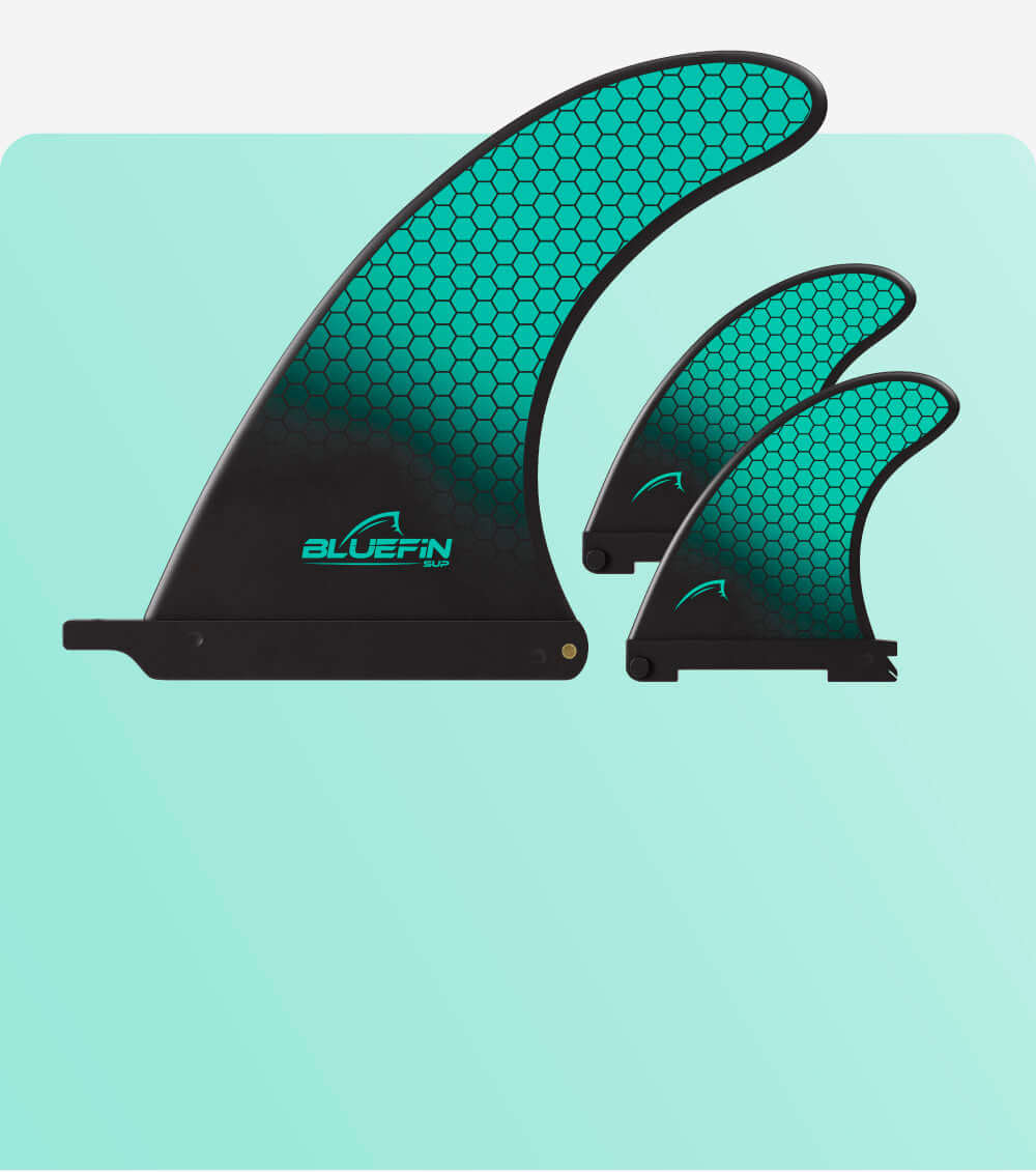 Bluefin SUP fins in three sizes, featuring a teal honeycomb design on a black base.