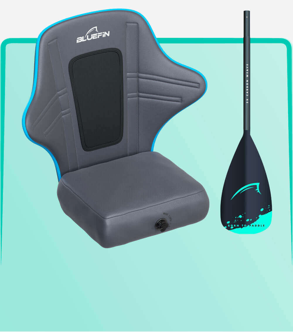 Gray inflatable seat with blue trim and back support next to a black paddle with teal accents.