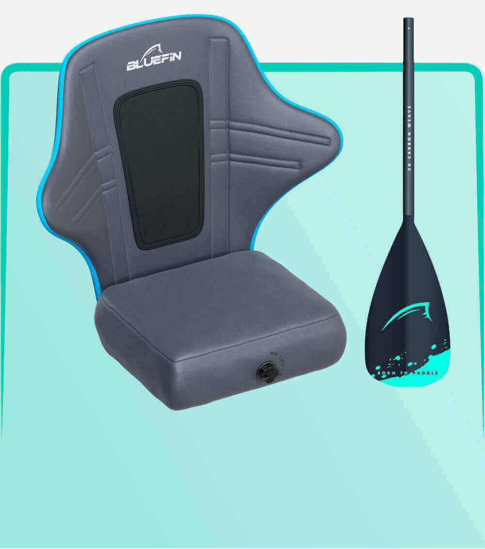 Gray inflatable seat with blue trim and back support next to a black paddle with teal accents.