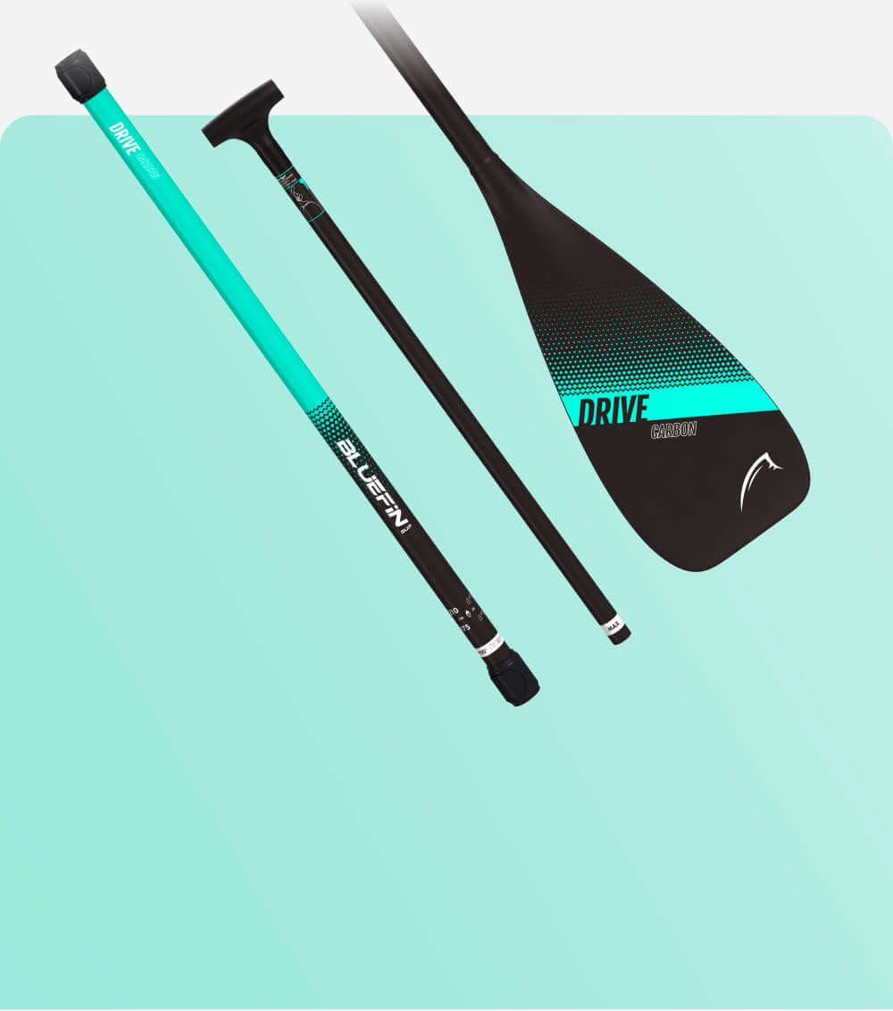 Bluefin SUP Drive carbon paddle with teal accents against a mint green background.