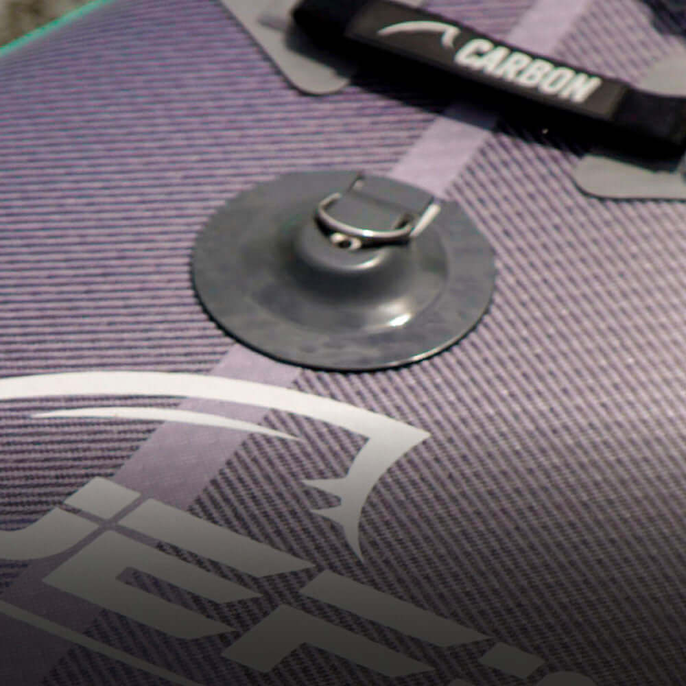 Close-up of a paddleboard's textured surface with a suction cup and strap, showing brand logo details.