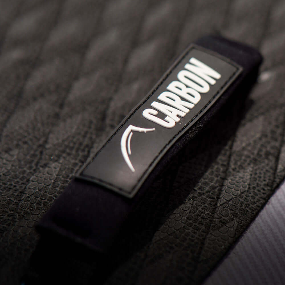 Close-up of a textured surface featuring a strap labeled "CARBON" in bold white letters.