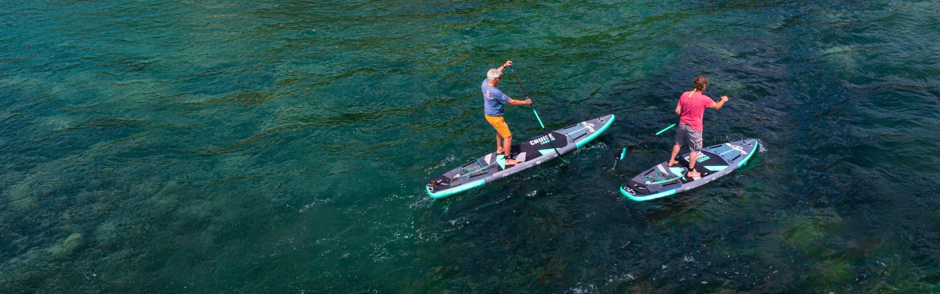 Two people on a Bluefin Cruise Carbon inflatable sup paddle board in the middle of the ocean
