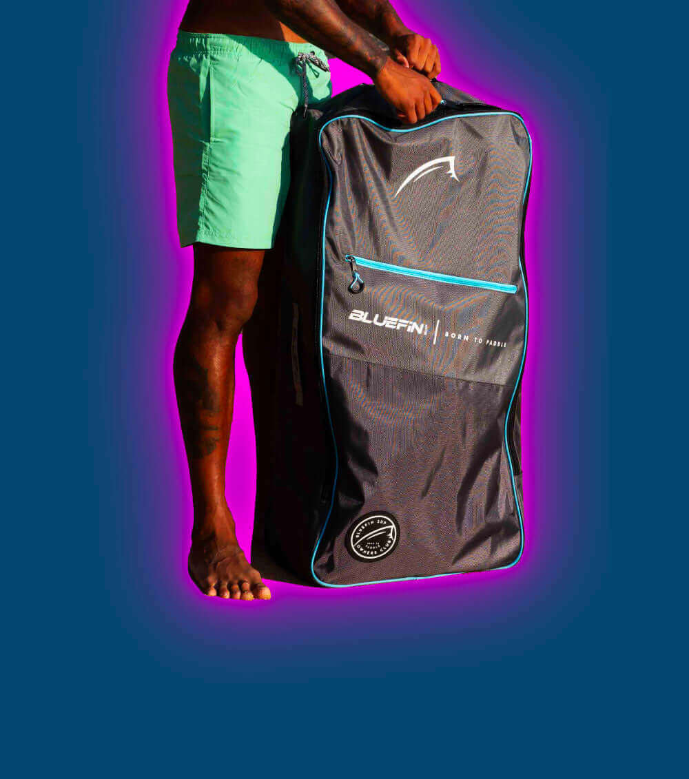 A person holds a Bluefin SUP bag in vibrant colors, showcasing a sporty outdoor vibe.