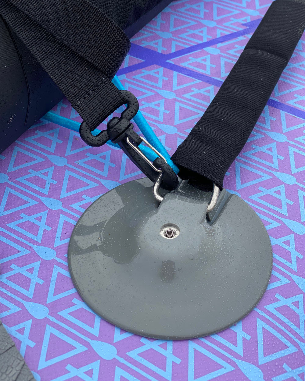 close up shot of the dri-tide bag being attached to the d-rings on an inflatable sup