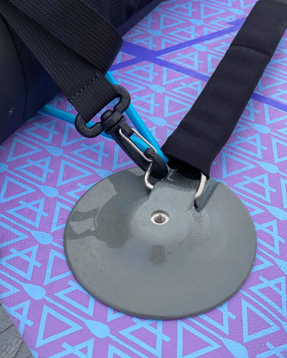 close up shot of the dri-tide bag being attached to the d-rings on an inflatable sup