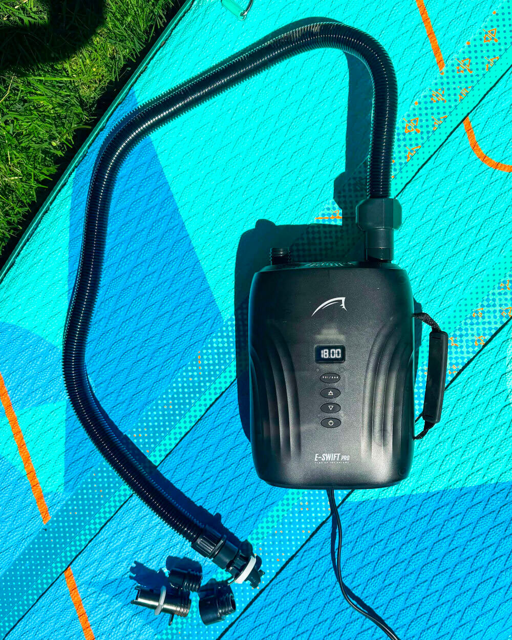 A portable electric pump with a digital display, several valve fittings and a power cord. For inflating a stand up paddle board on a Lite paddleboard