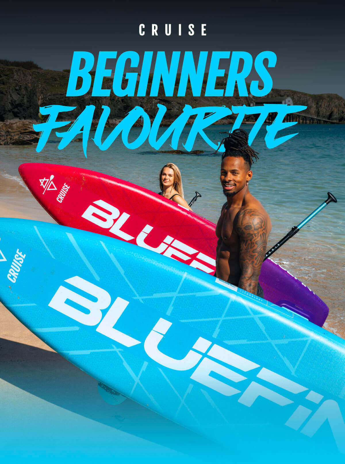 Two paddleboarders on a beach holding blue and red Bluefin paddleboards with a scenic background.