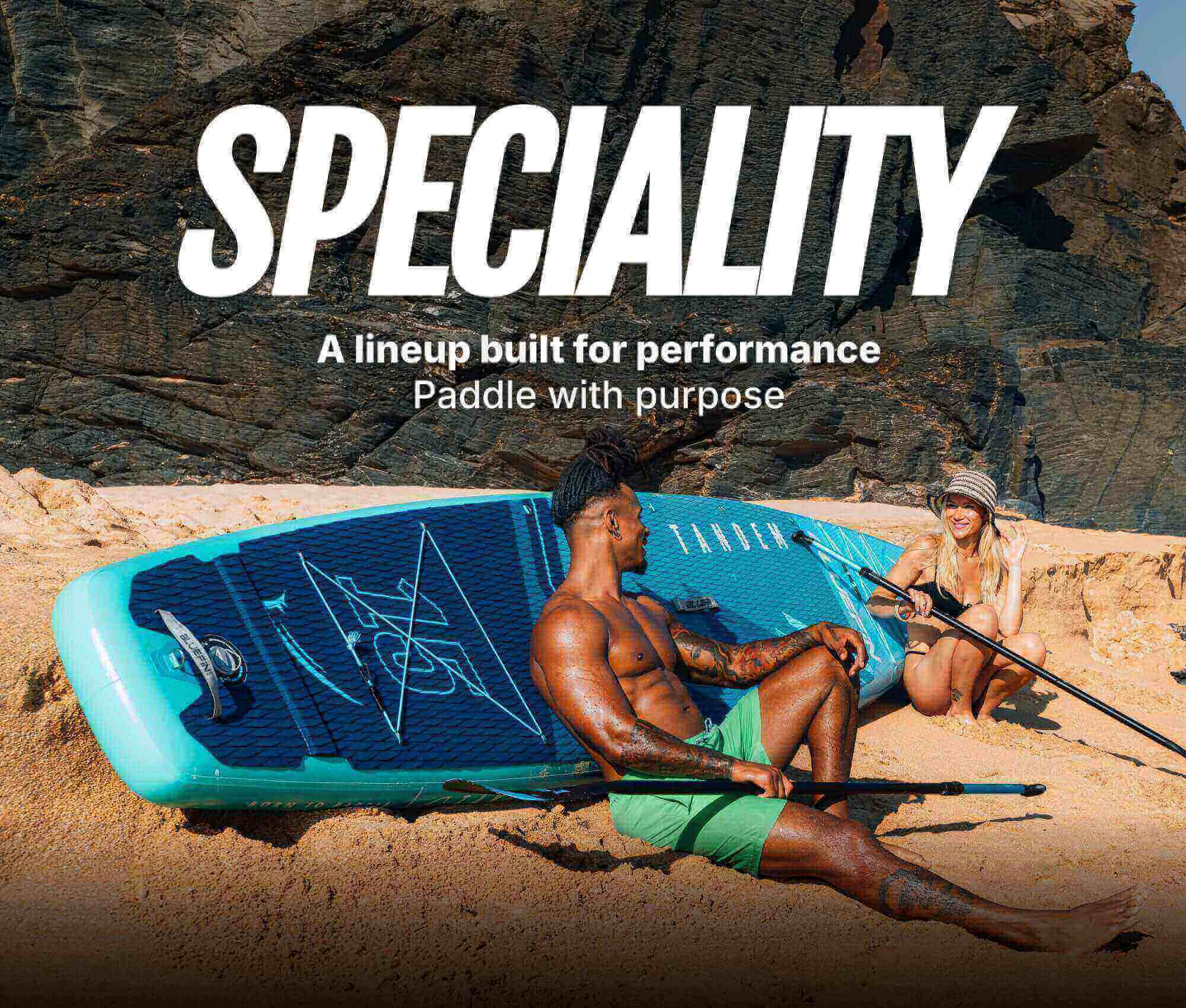 Couple relaxing on a beach with a paddleboard, promoting performance and purpose in paddleboarding.