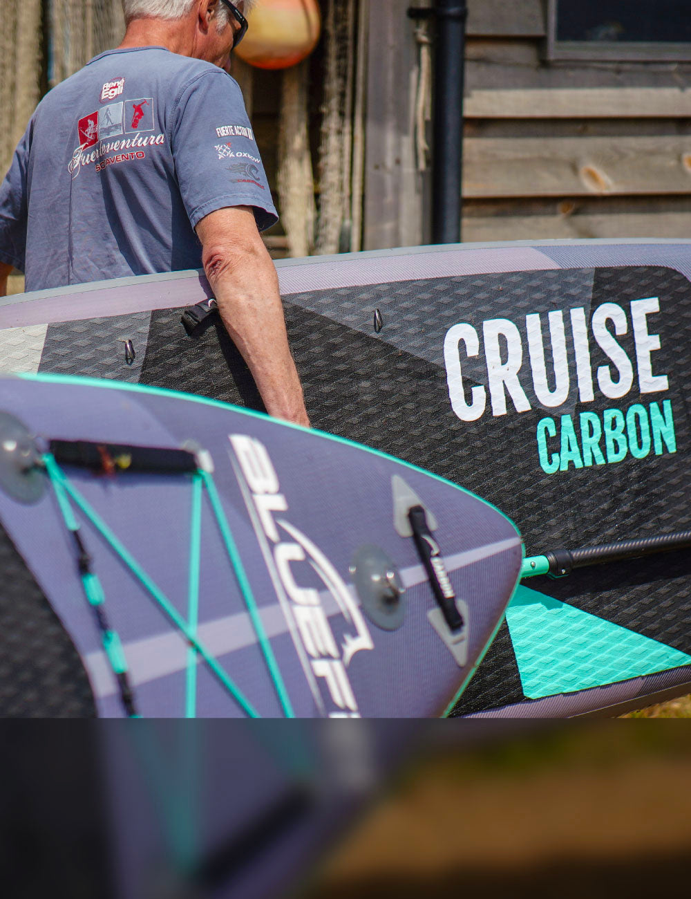 Two people holding Bluefin cruise Carbon Sup