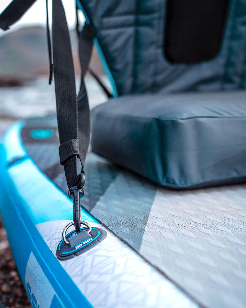 Close-up of a strap attached to an inflatable kayak seat to a bluefin stand up inflatable paddle board