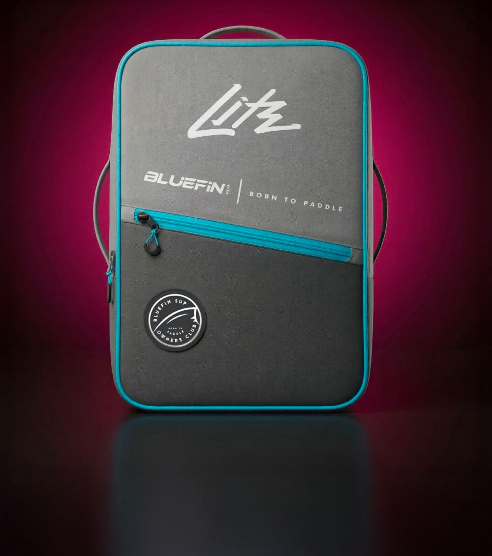 Gray backpack with blue zipper, featuring Bluefin logo and round patch on front.