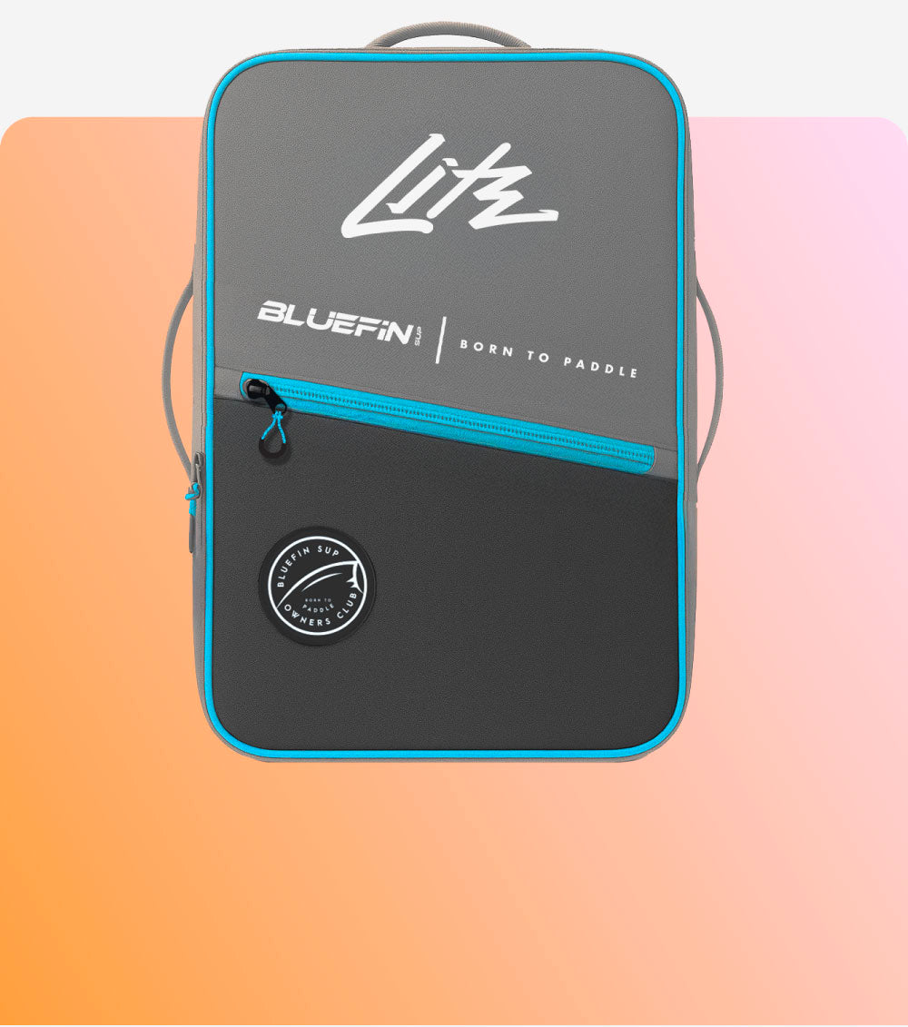 Bluefin SUP backpack with a sleek gray design and aqua accents against an orange gradient background.