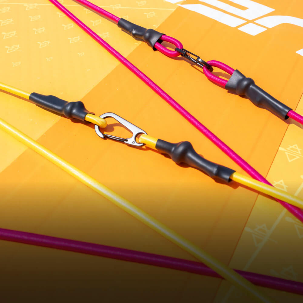 Colorful SUP lines with metal clips against a bright orange board background.