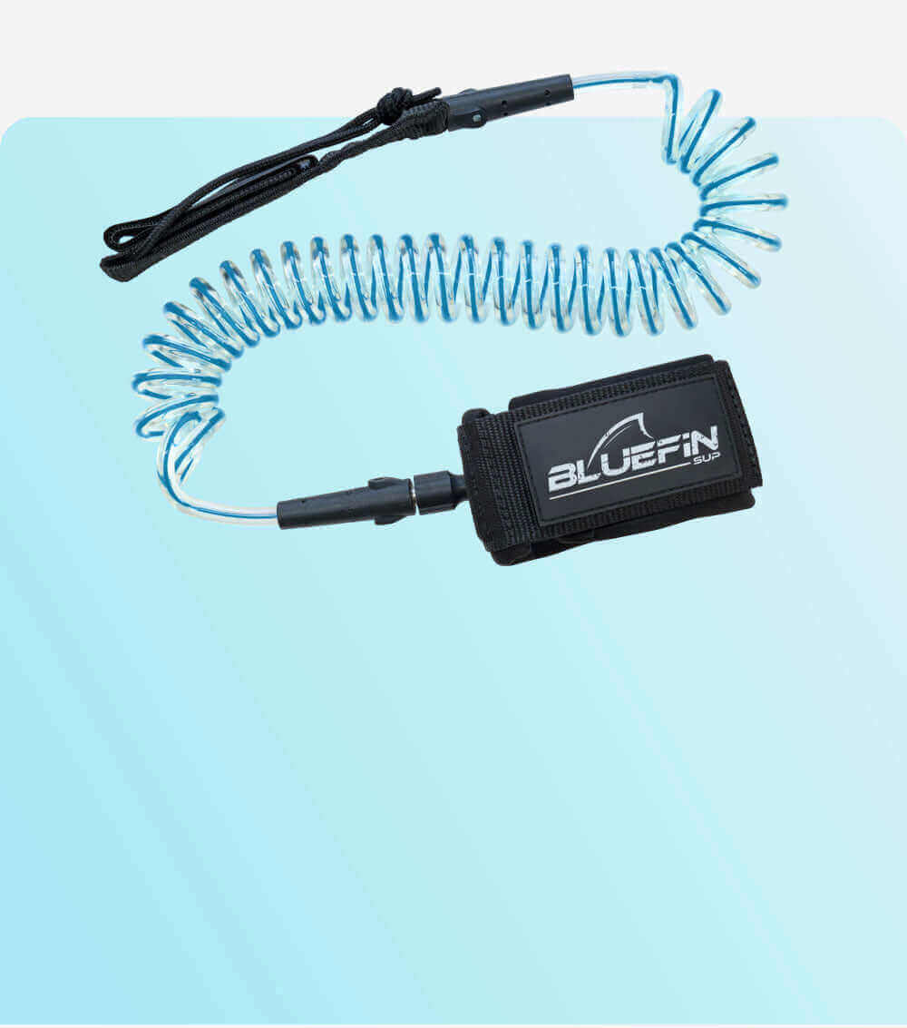 Bluefin SUP coiled SUP leash with adjustable strap on a blue gradient background.