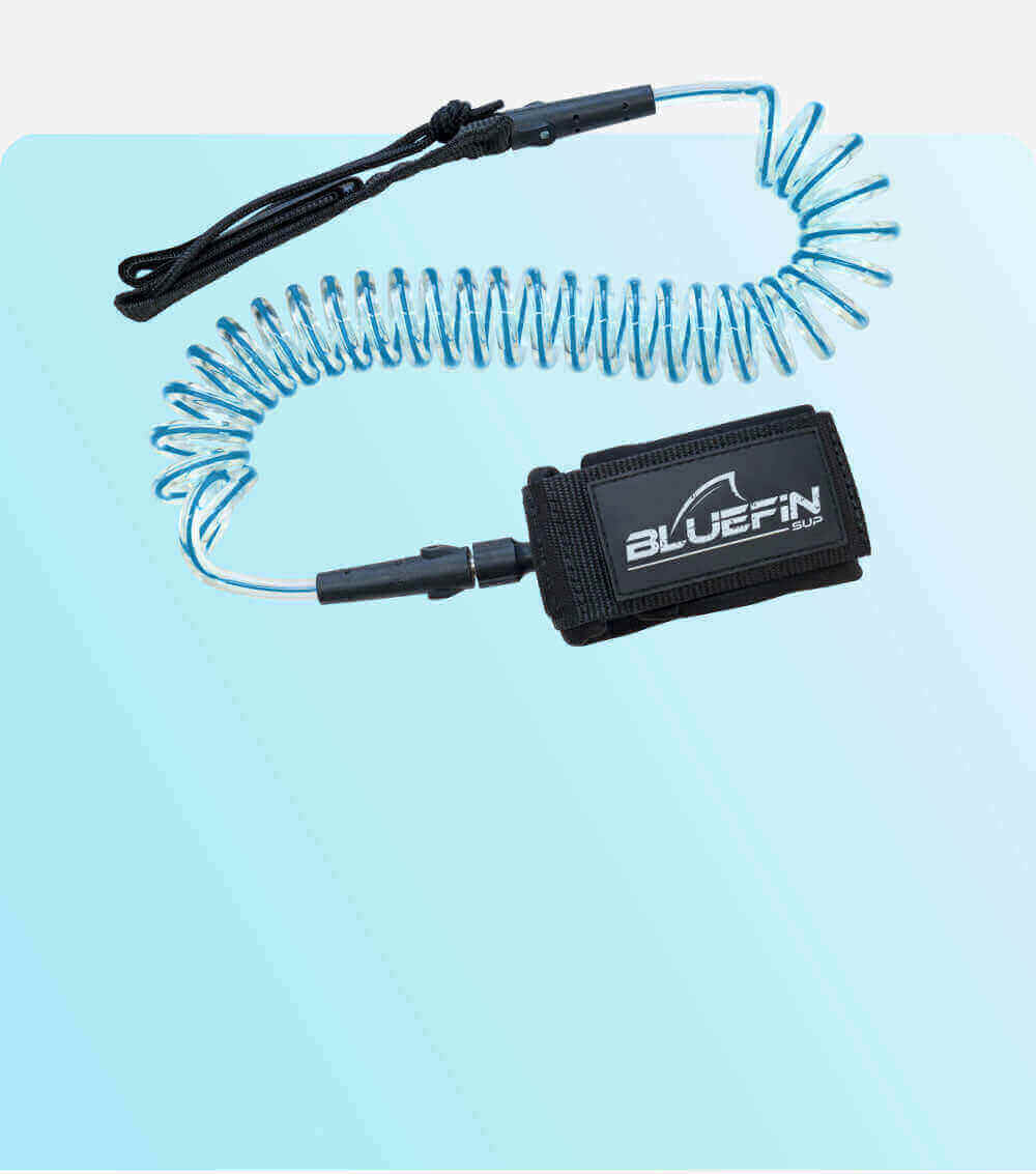 Bluefin SUP coiled SUP leash with adjustable strap on a blue gradient background.