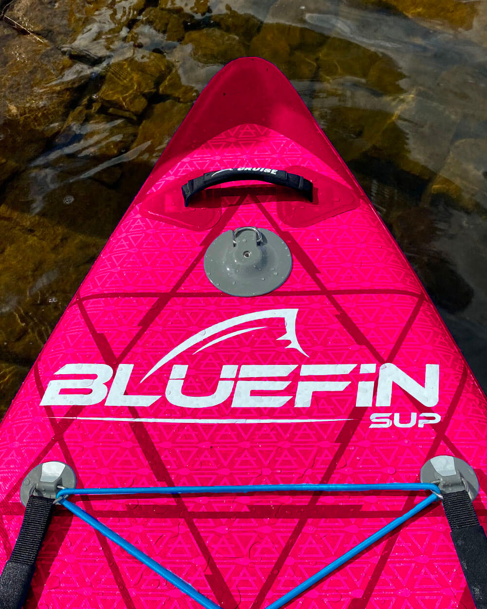 berry red cruise Bluefin SUP board with geometric pattern on a water background