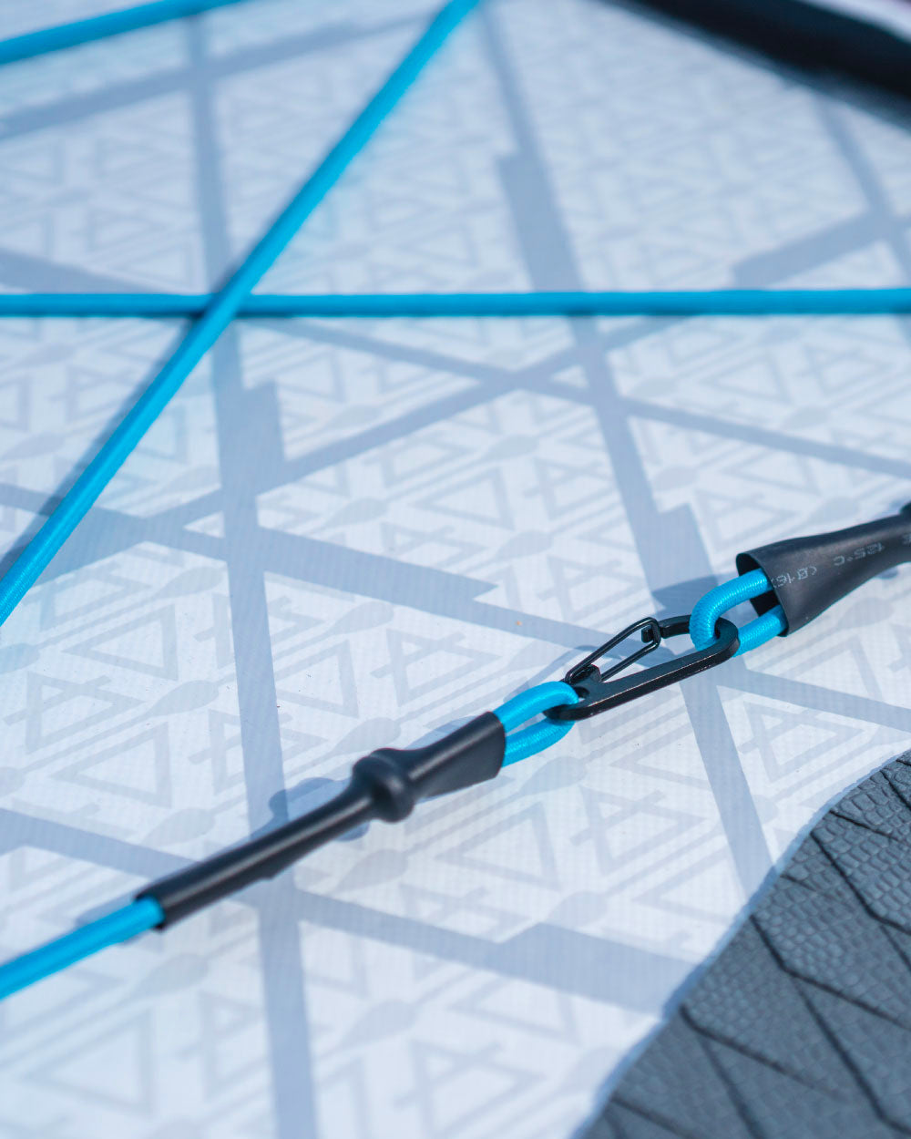 Close-up of a blue and black bungee cords on a bluefin cruise inflatable stand up paddle board