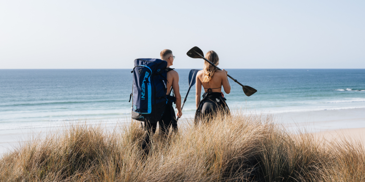 two people looking out at the oceon