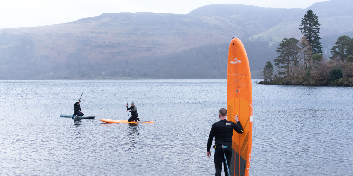 man about to get into the water with paddleboard