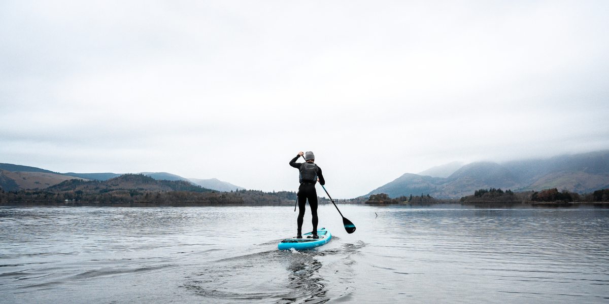 man paddleboarding in a lake