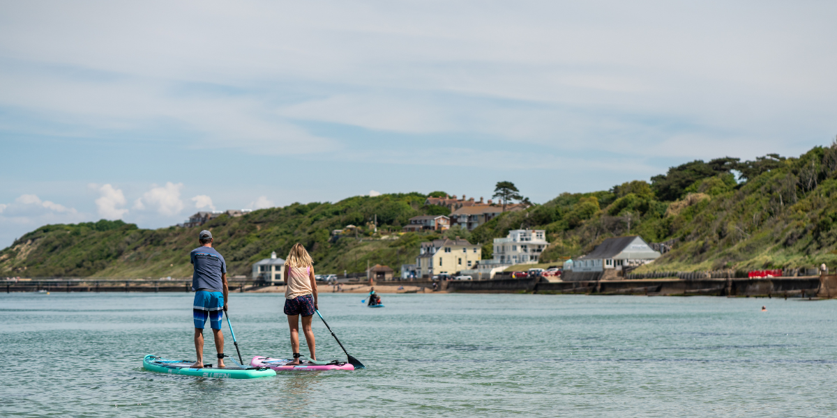 two people paddleboarding