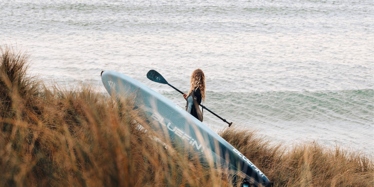 woman holding paddleboard