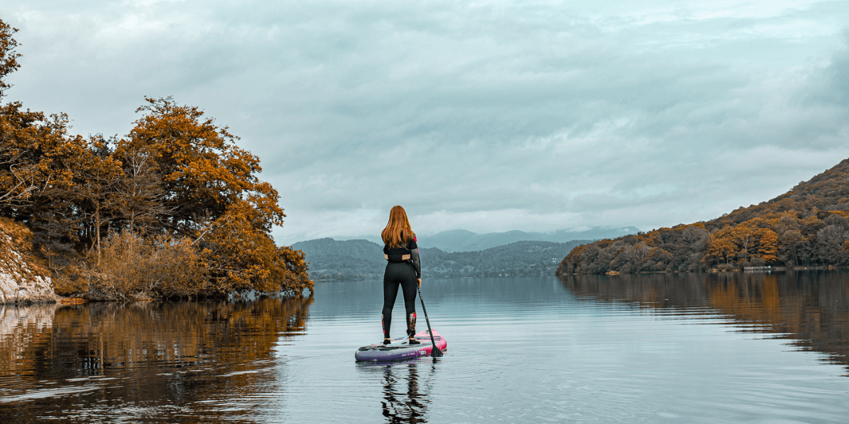 woman paddle boarding in a lake