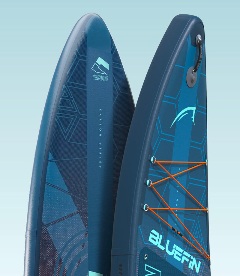 Two Bluefin SUP paddleboards with textured surfaces, center fins, and orange bungee cords for gear storage
