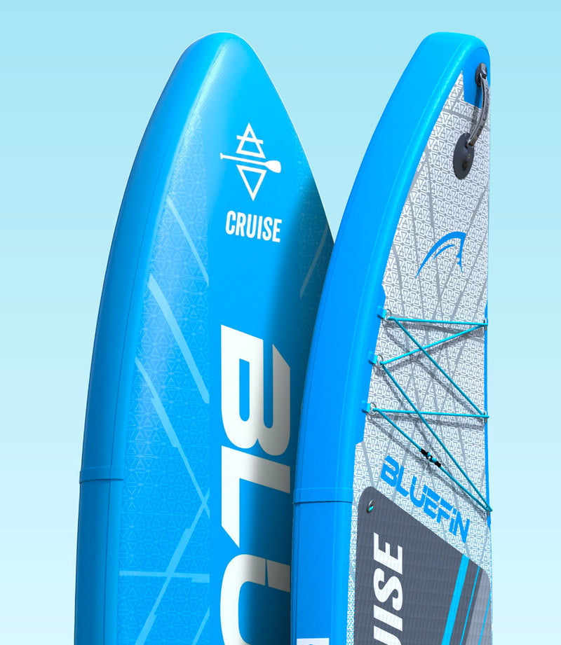 Two blue inflatable paddleboards with textured surfaces and bungee cords for gear storage