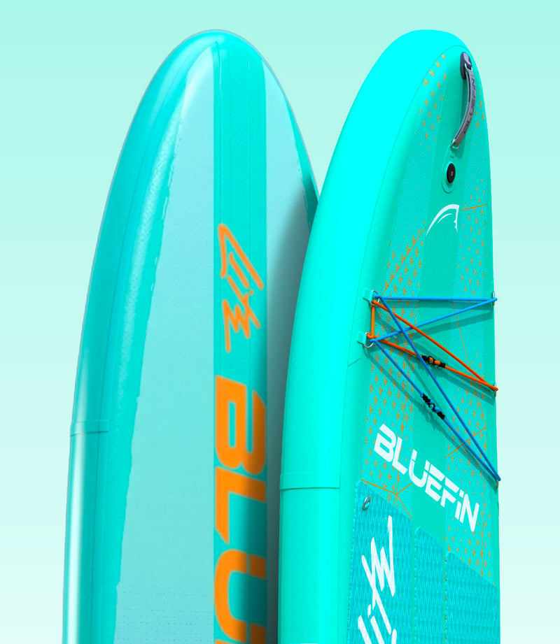 Two blue inflatable paddleboards with textured surfaces and orange accents, showcasing fins and handles.