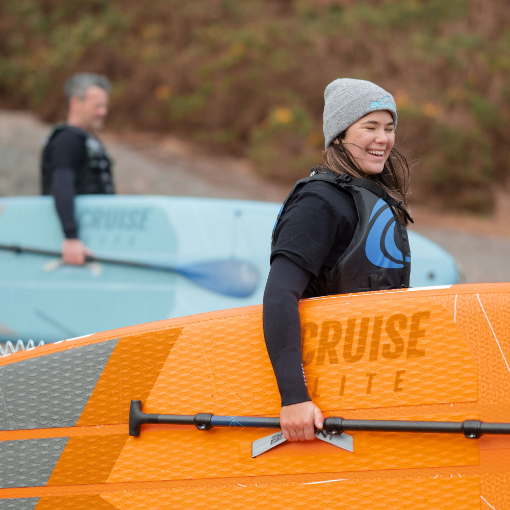 Cruise Lite Orange 10' Inflatable Paddle Board - Happy woman smiling with SUP