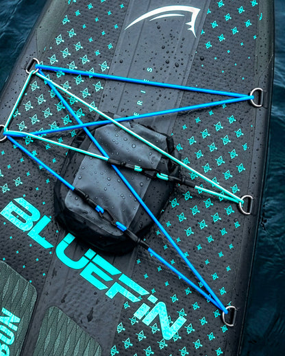 Inflatable paddleboard with blue bungee cords, textured surface, and a black storage bag on top