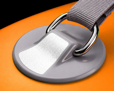 Close-up of a gray D-ring attachment on an inflatable paddleboard with an orange surface.