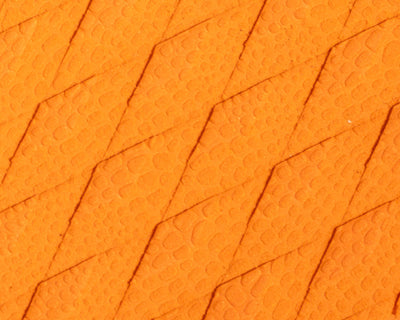 Textured orange surface with diamond patterns and small raised dots, resembling reptile skin.