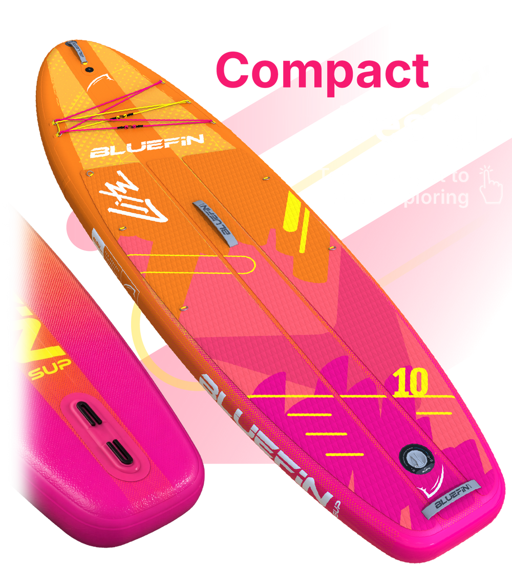 Inflatable paddleboard in orange and pink with textured deck, center fin, and inflation valve
