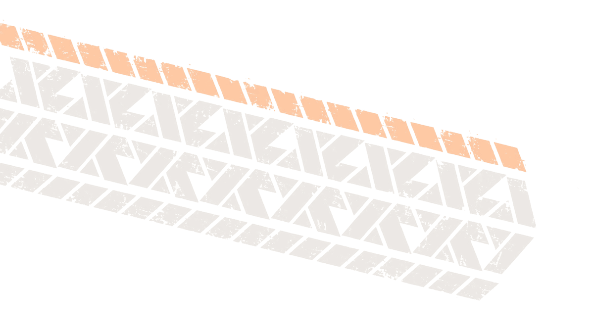 Tire tread pattern in brown and orange with a textured design, showing wear and dirt marks.