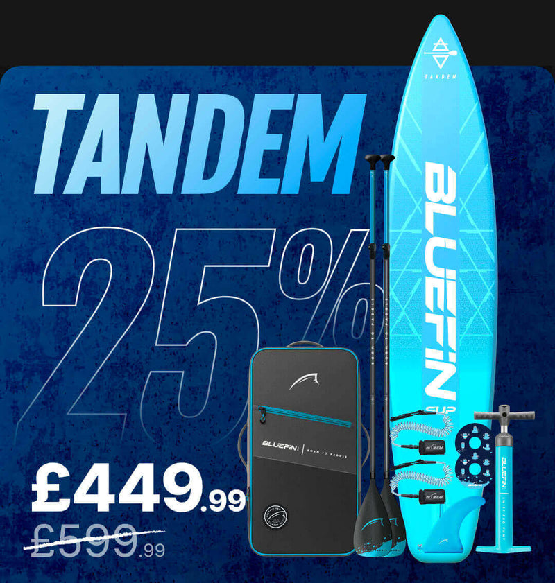 Inflatable tandem paddleboard in blue with paddles, pump, and carrying bag, marked down to £449.99