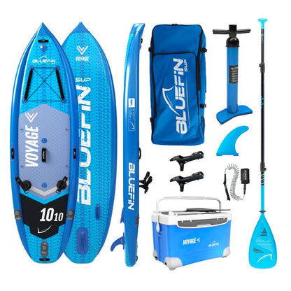 Bluefin SUP Voyage bundle with inflatable paddleboard, pump, paddle, fin, backpack, and cooler.
